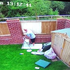 CCTV of dad painting a fence and knocking the paint pot off the ladder and over himself