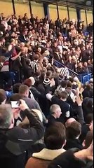 football fans cheer on lad as he slides down the stair railing and then gets a round of applause