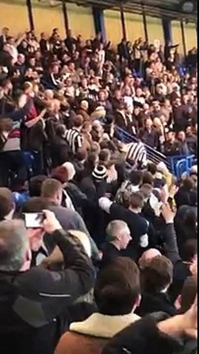 football fans cheer on lad as he slides down the stair railing and then gets a round of applause