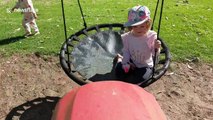 Ingenious father backs up lawn mower to push daughter on swing