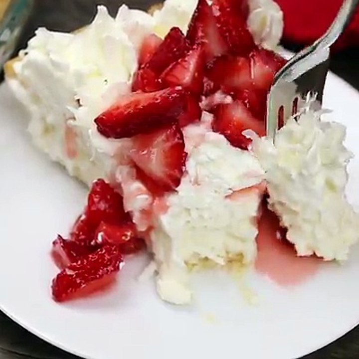 White Christmas Pie! A luscious, creamy coconut custard pie with whipped cream and strawberries on top! See the printable recipe here: