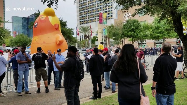 Protestors gather around Trump baby blimp outside Republican rally in Houston