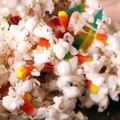 Halloween candies turn these old-fashioned popcorn balls into fun party favors! Get the recipe: