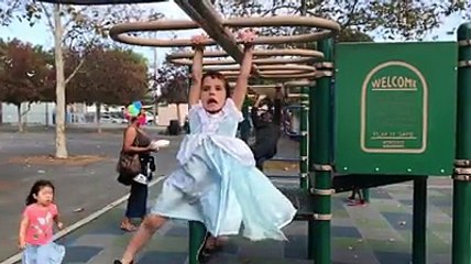 Two year old girl doing funny  act during play