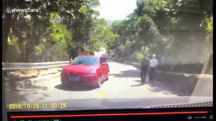 Car loses control on slope and slides down before flipping over