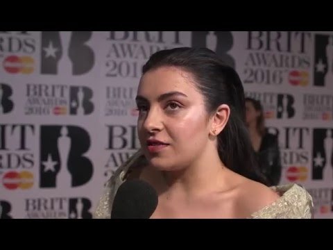 Charli XCX on the Brits 2016 red carpet with James Barr