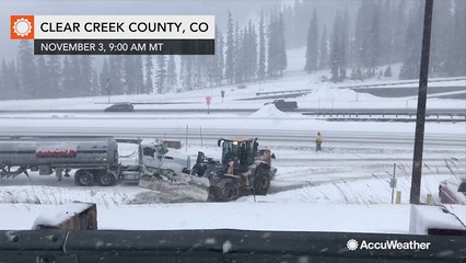 Vehicles seen stranded in snow under poor road conditions