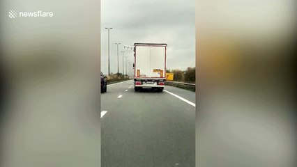 Moment migrants stick a ladder out of a moving lorry in a bid to escape