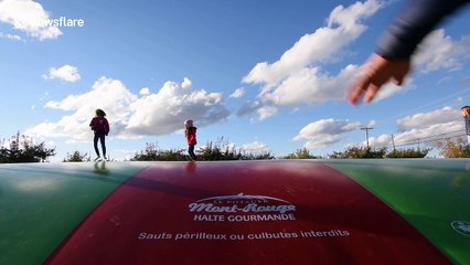 YouTuber dad tries to impress kids by doing backflips on inflatable fun pad