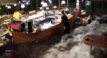 Wave crashes through windows of Italian restaurant