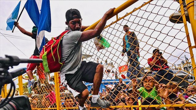 Asylum Seekers Smash Mexican Border Waving Honduran Flags
