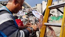 Palestinians inspect ruins of Hamas TV station after Israeli air strike on Gaza