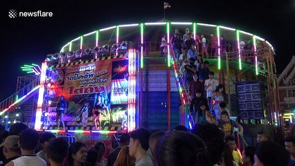 Pick-up truck takes on motorcycle wall of death at Thai fair