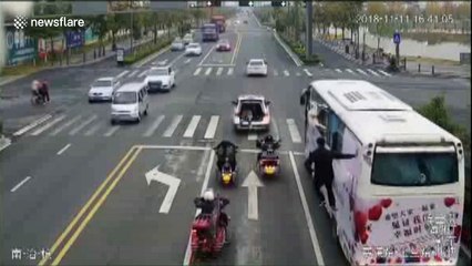 Chinese man hangs on the side of moving coach for promotional campaign