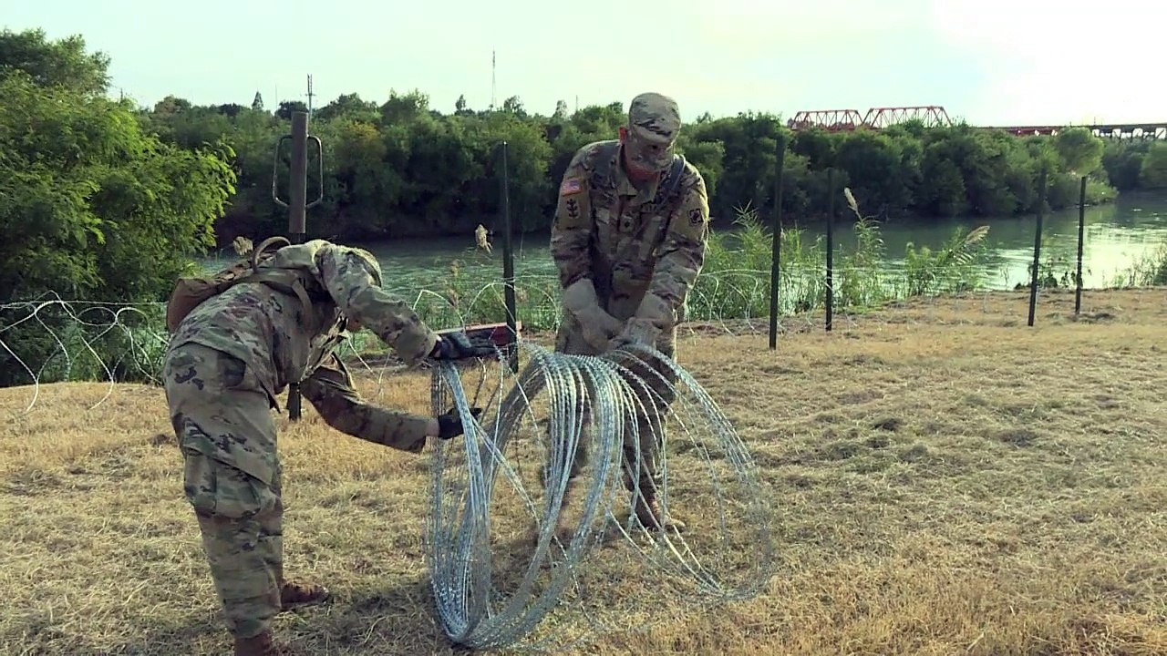 US military place barbed wire at the border with Mexico