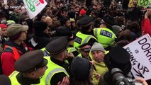 Scuffles break out as police force their way into London climate protest