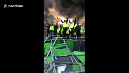 Fuel tax protesters light fire on Champs-Elysées in Paris