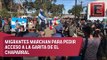 Migrantes se alistan para marcha en garita El Chaparral en Tijuana