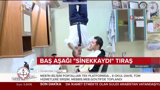 Tavandan baş aşağı asılarak tıraş yapan berber
