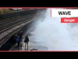 Children risking their lives by dodging huge waves on the wrong side of a seawall | SWNS TV