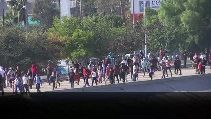 Migrants hit with tear gas at U.S. border