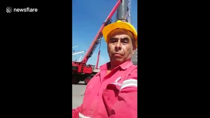 Men left hanging metres in the air after crane falls in freak accident