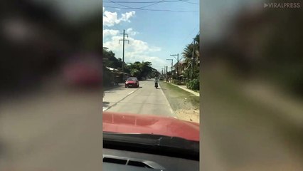 Old Man Stands On Moving Motorcycle