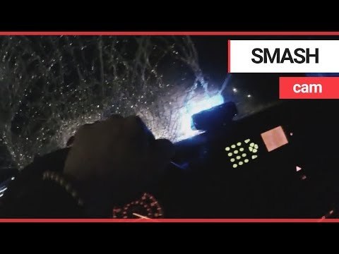 Shocking dashcam captures moment thugs smash police car with sledgehammers | SWNS TV