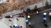 Chinese university students slip on icy ramp road following rainfalls