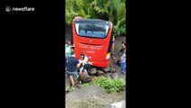 At least 25 injured as bus skids off bridge in the Philippines