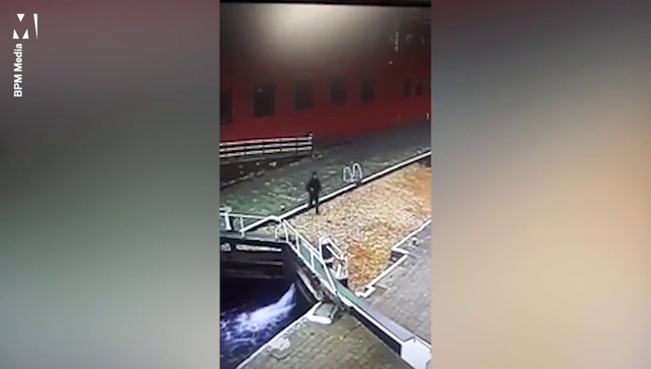 Man walks straight into canal while on the phone