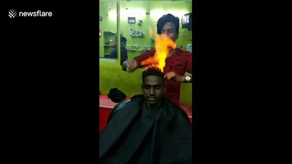 Drop the scissors! Indian barber trims customer's hair by setting it on FIRE