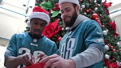Eagles team up to help wrap holiday gifts at Liberty Place