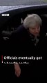 Theresa May gets locked inside her car as she arrives to meet Angela Merkel - video