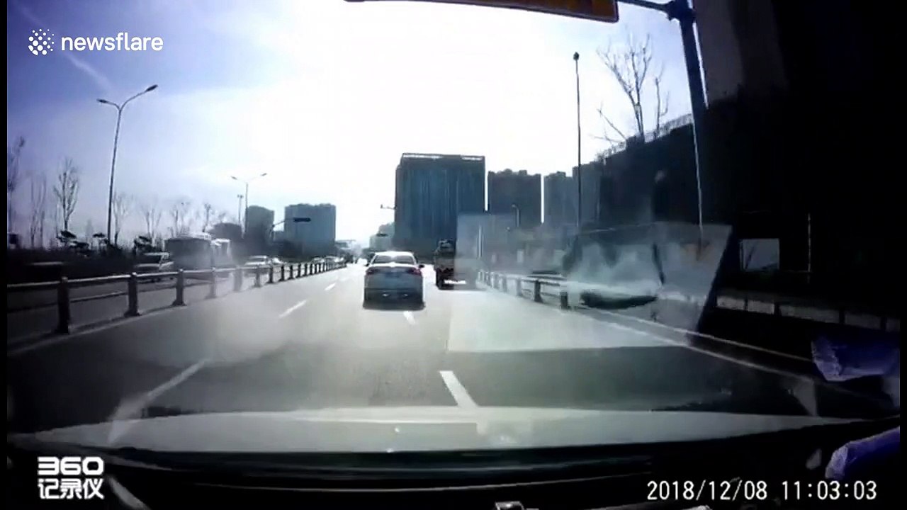 Boy falls out of back of a minibus onto busy road in China