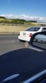 Car Drags Muffler down Highway