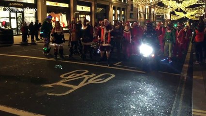 Skating Santas stream through central London