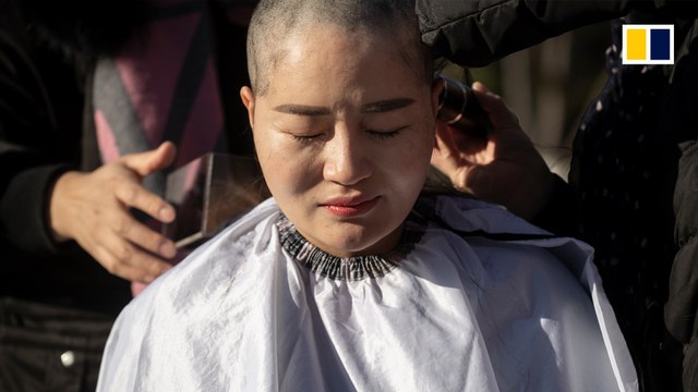 Wives of detained Chinese human rights lawyers shave heads in protest