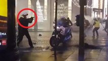 French policeman pulls gun on protesters