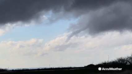 Rope funnel cloud spins above ground