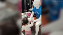 Toddler Greets Mannequins With Handshakes