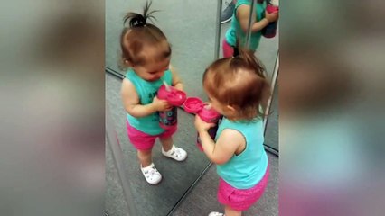 This little girl doesn't quite understand mirrors