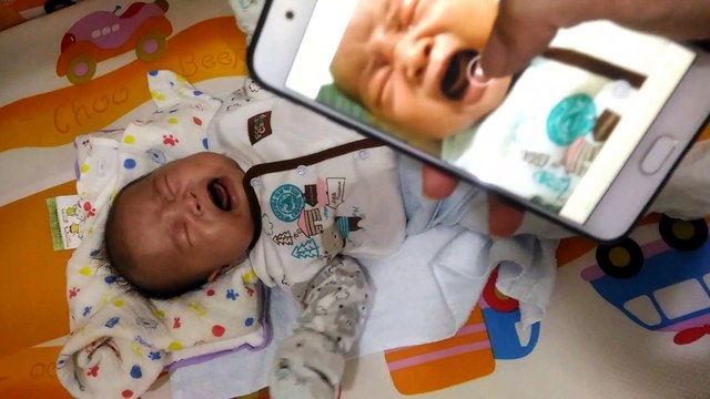 Baby stops when he sees himself crying on camera