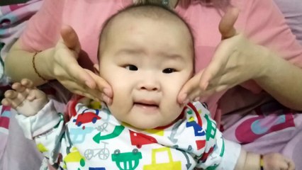 This baby hates massage his face