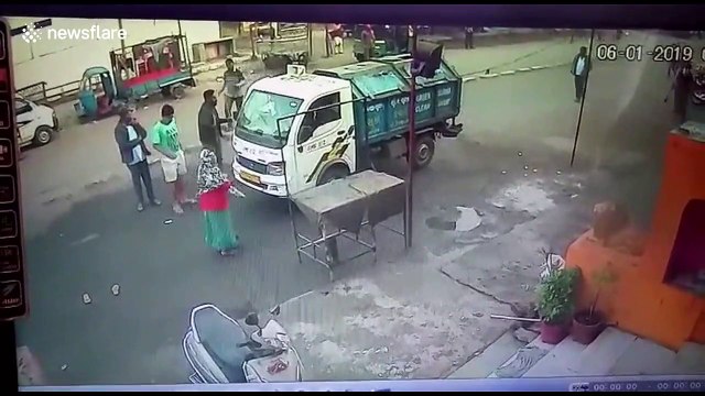 Lucky escape for 50-year-old woman as garbage truck reverses over her