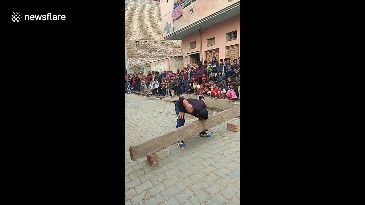 Iron-jawed Indian man throws 60kg log over his head using only his teeth