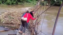 Teachers Make Perilous Commute To Classroom By Walking Across Half-Sunken Rope Bridge