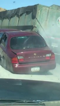 Un camion traîne une voiture sur l'autoroute sans se rendre compte de rien