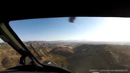 Watch two helicopter pilots performing a daring wildfire rescue