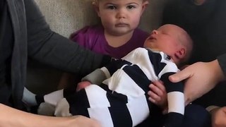 Toddler is hilariously unimpressed by new baby brother